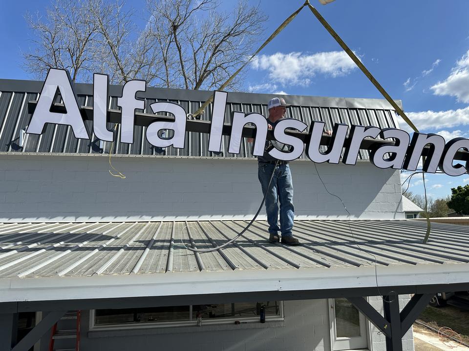 Alfa Insurance letters being craned into place